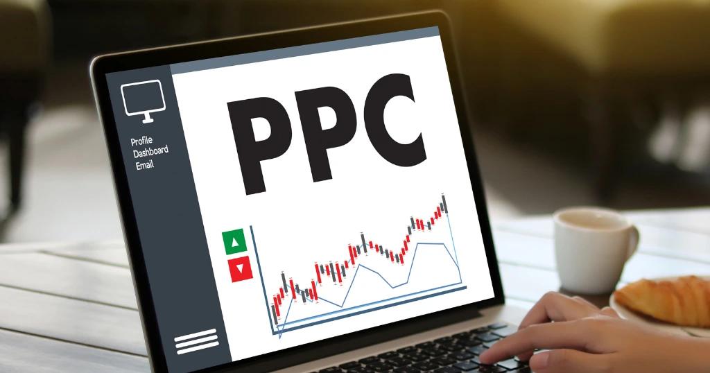 A person reviewing Local Service Ads in London on a laptop, showing PPC analytics with stock market-style graph indicators.