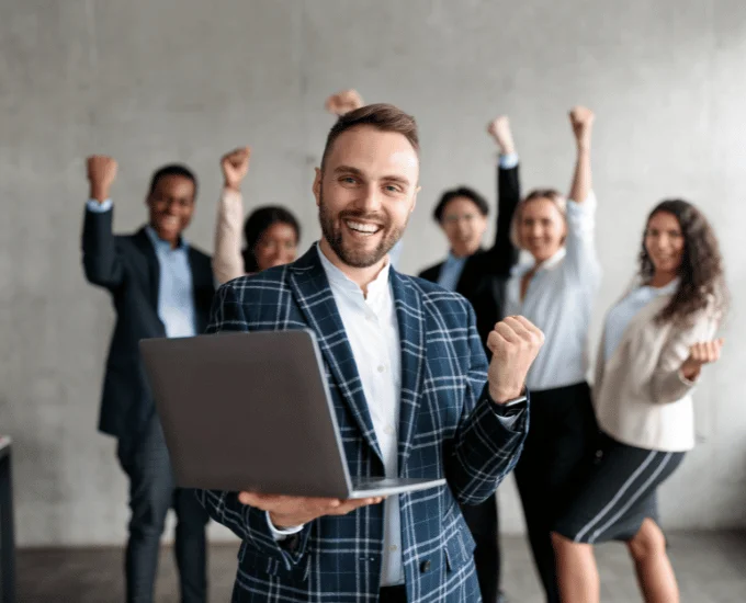 Confident consultant celebrating successful marketing and SEO services in the UK with a dynamic team, showcasing website development achievement